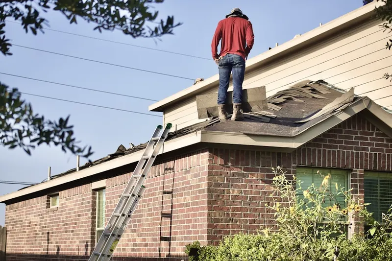 Professional roofer working on a residential roof in Woody